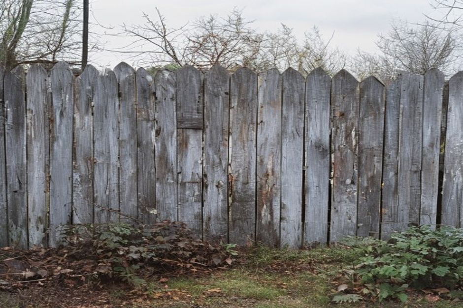 An old weathered wood fence before removal and replacement